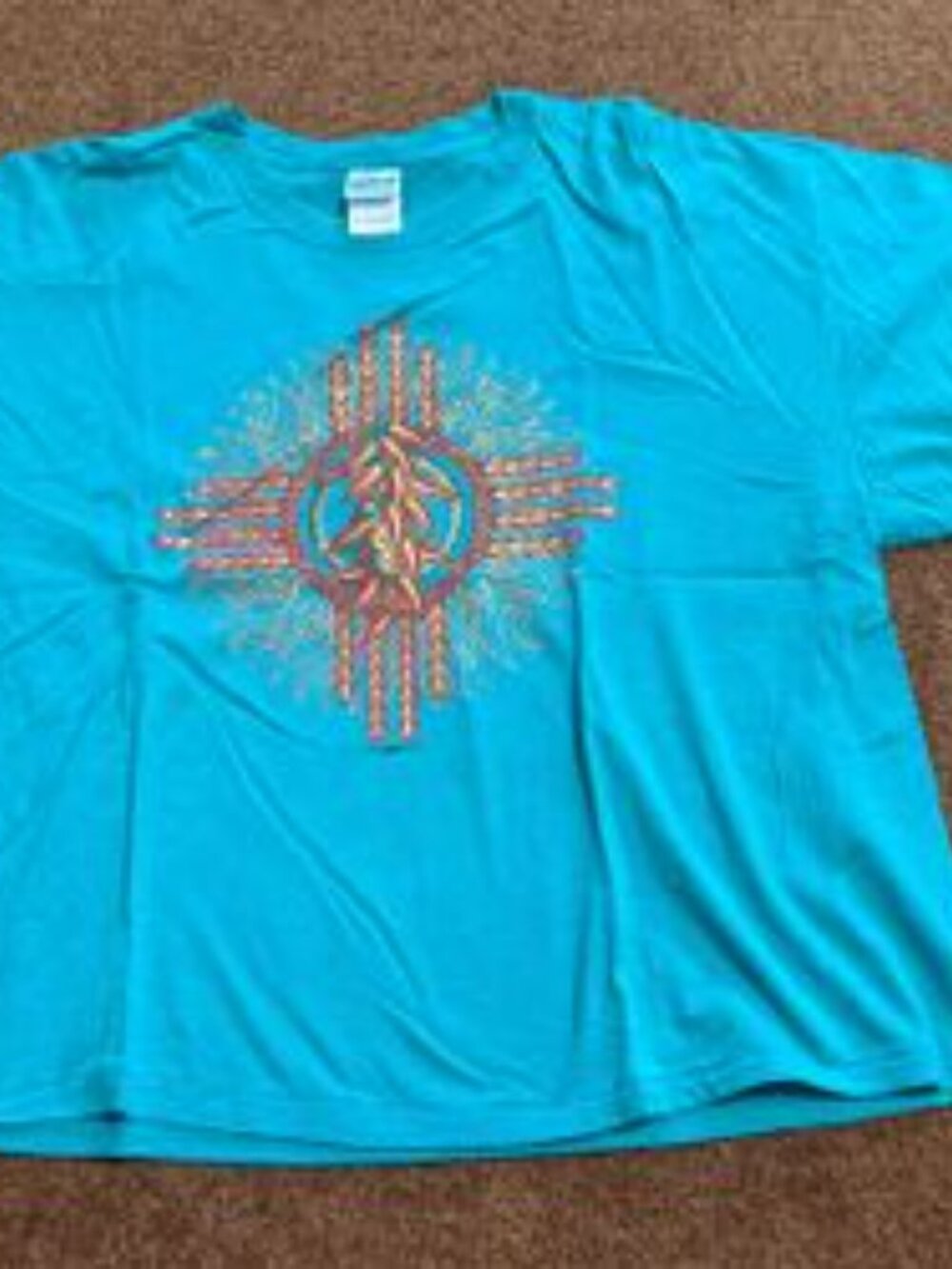 Vintage 1998 New Mexico Zia sun symbol filled with chili peppers.